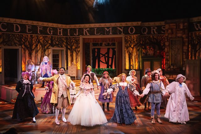 Fairy tale characters stand on stage in Into The Woods